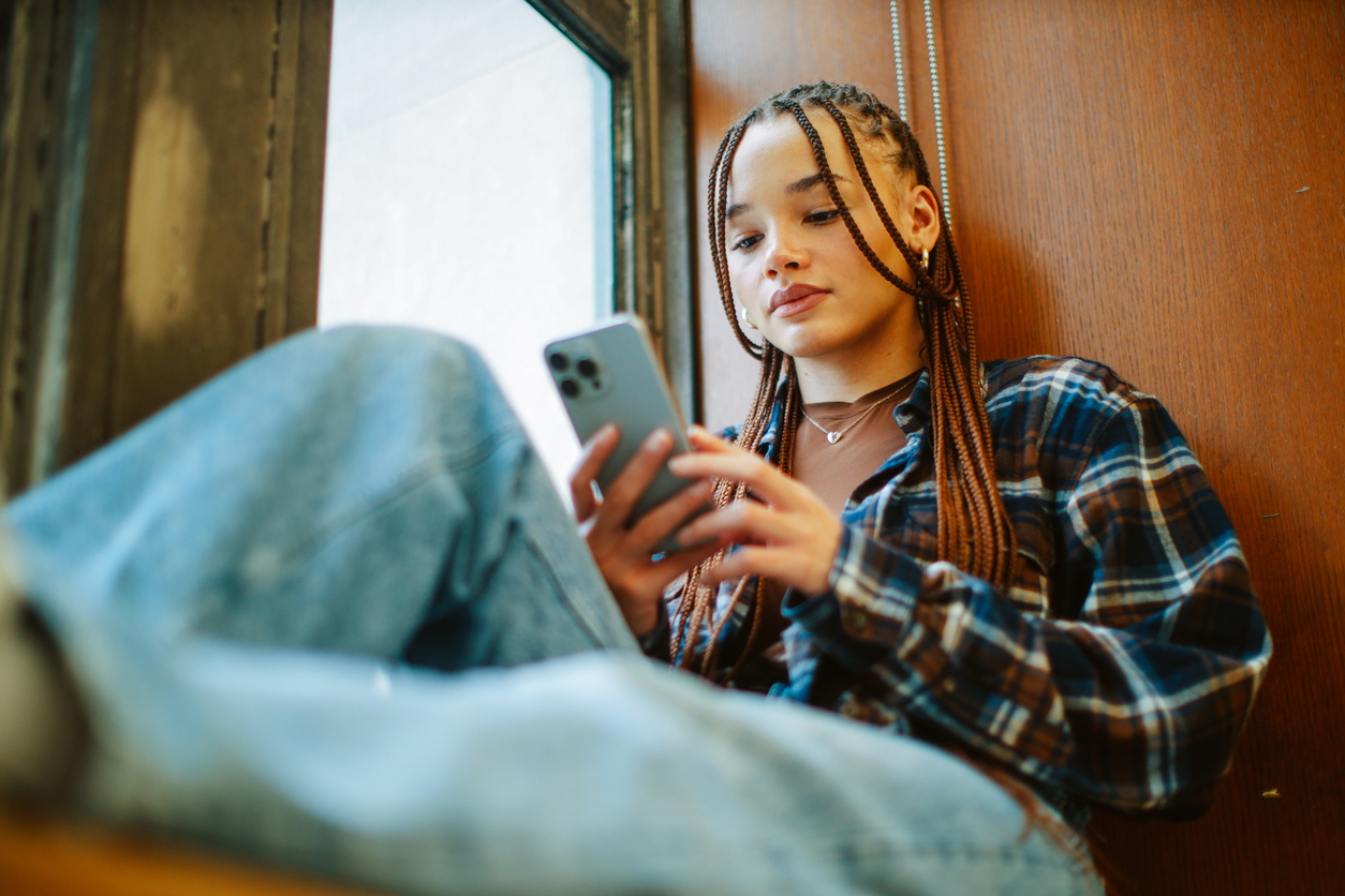 student texting on her phone